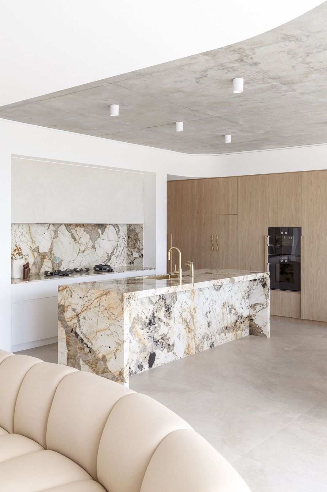 Minimalist kitchen with clean lines, flat-panel cabinets, and a monochromatic color scheme Patagonia marble countertops